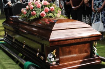 Coffin being gently lowered into burial plot - Funeral Blog | iMortuary.com